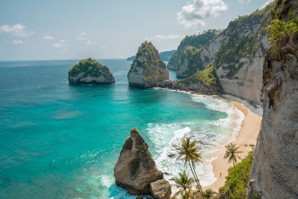 Beach with teal water against the cliffs in Bali