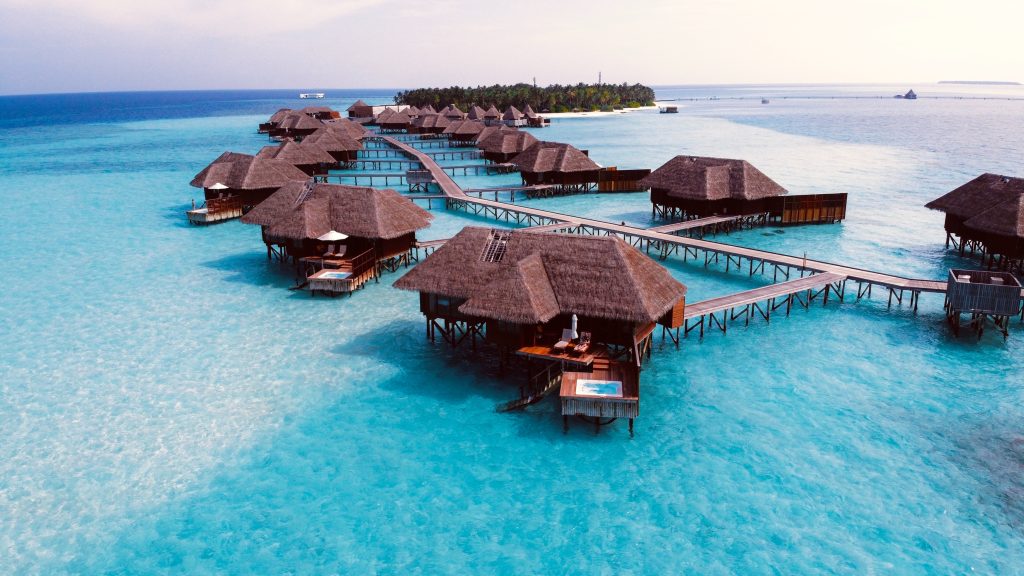 floating hut cabanas on blue water in the Maldives